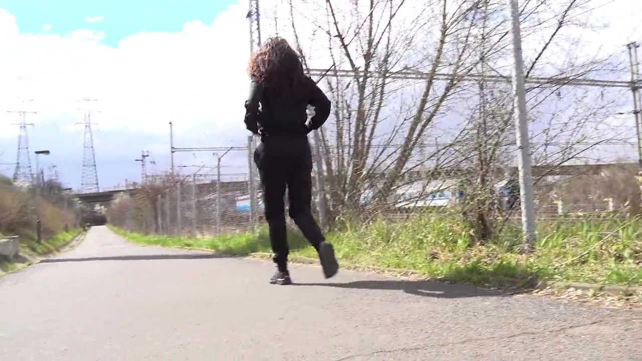 Ali B squats to pee next to the tramline